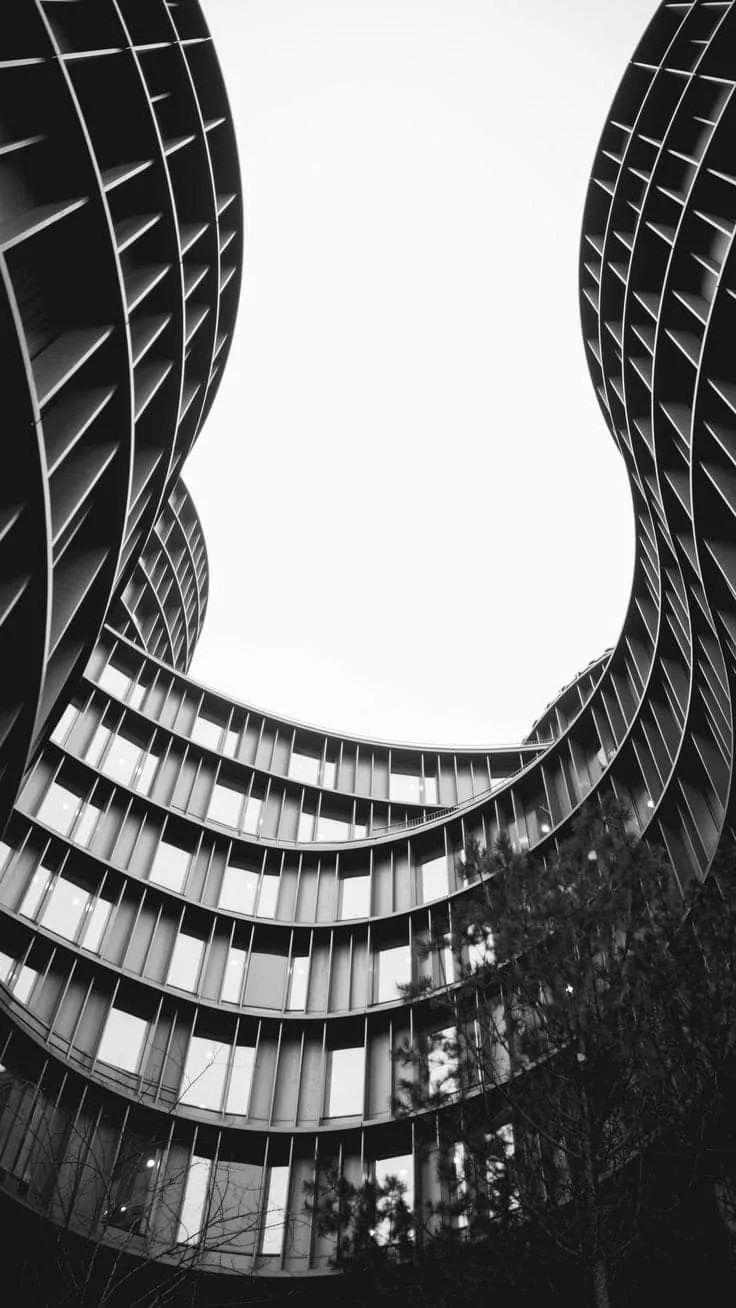 Curved building facades, looking up at the sky